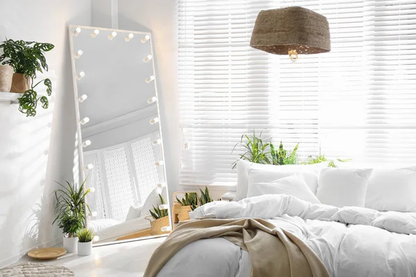 モダンなベッドルームで電球とスタイリッシュなミラー インテリアデザイン — ストック写真