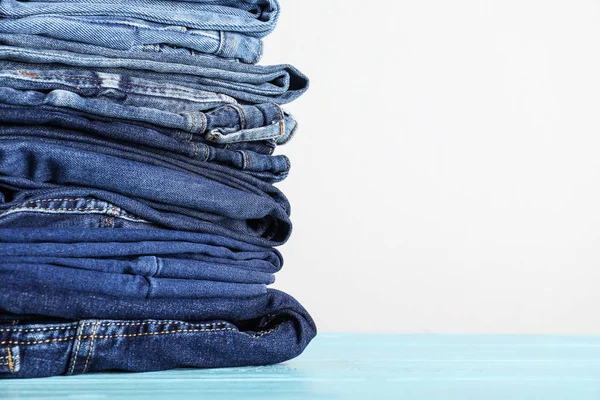 Stack Different Jeans Blue Wooden Table Space Text — Stock Photo, Image