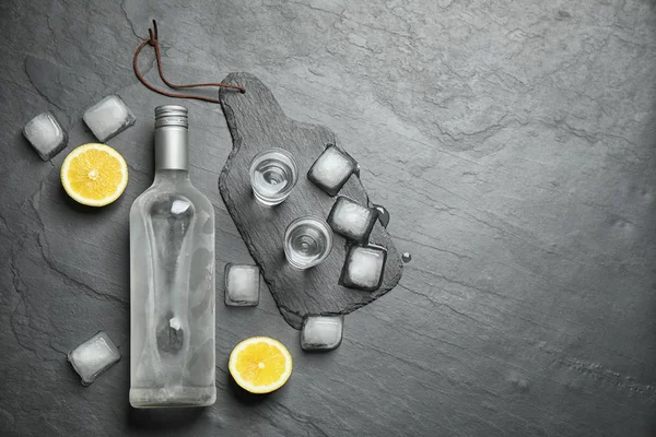 Flat lay composition with cold Russian vodka on black table. Space for text