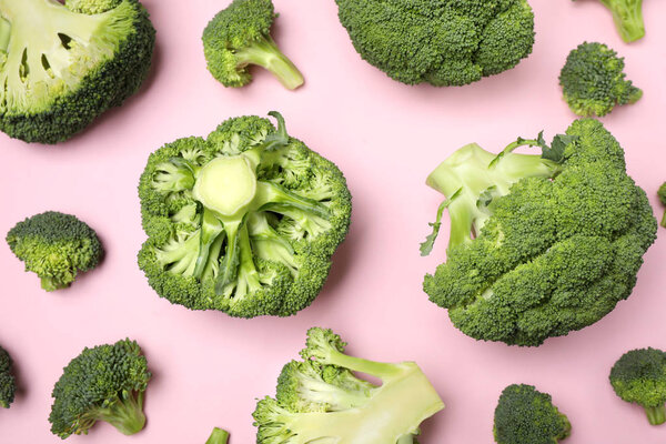 Fresh broccoli on pink background, flat lay