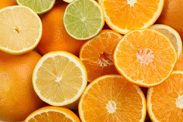 Tangerines and different citrus fruits as background, top view — Stock Photo, Image