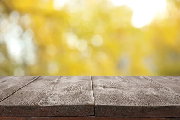 Empty wooden surface against blurred background. Bokeh effect