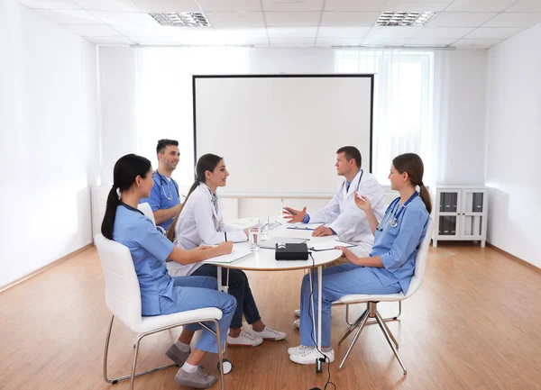 Team of doctors using video projector during conference indoors — Stock Photo, Image