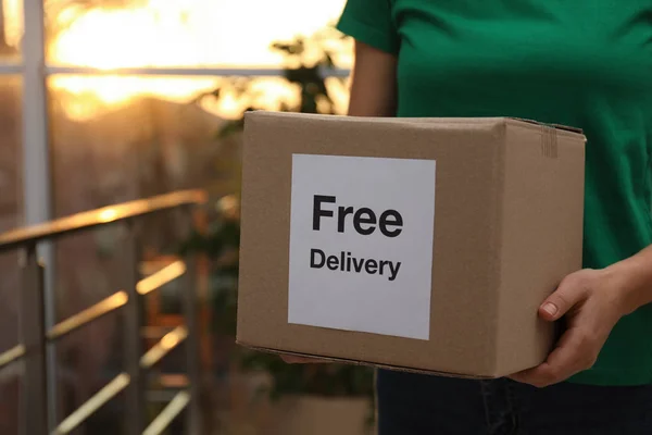 Courier Holding Parcel Sticker Free Delivery Indoors Closeup — Stock Photo, Image