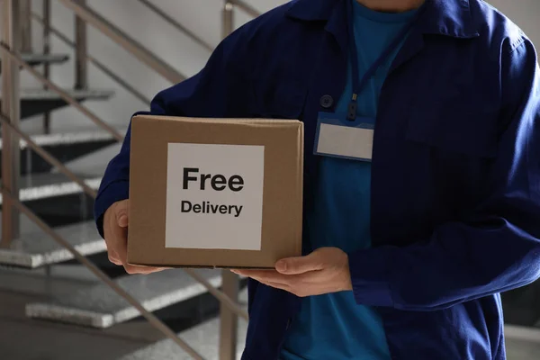 Courier Holding Parcel Sticker Free Delivery Indoors Closeup — Stock Photo, Image