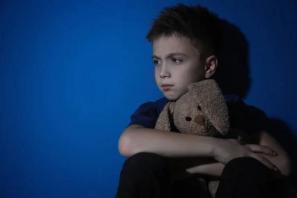 Sad Little Boy Toy Blue Wall Space Text Domestic Violence — Stock Photo, Image