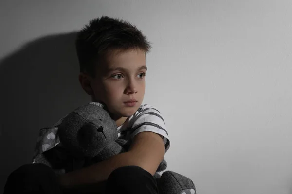 Sad Little Boy Toy White Wall Space Text Domestic Violence — Stock Photo, Image