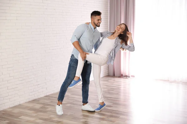 Adorável jovem casal dançando juntos em casa — Fotografia de Stock