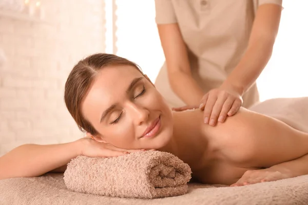 Young woman having body scrubbing procedure with sea salt in spa — Stock Photo, Image