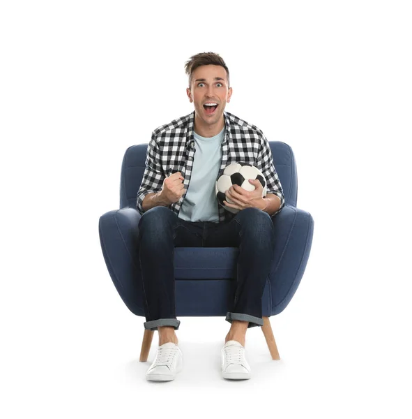 Handsome young man sitting in armchair and watching soccer match — 스톡 사진