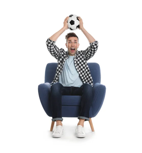 Handsome young man sitting in armchair and watching soccer match — 图库照片