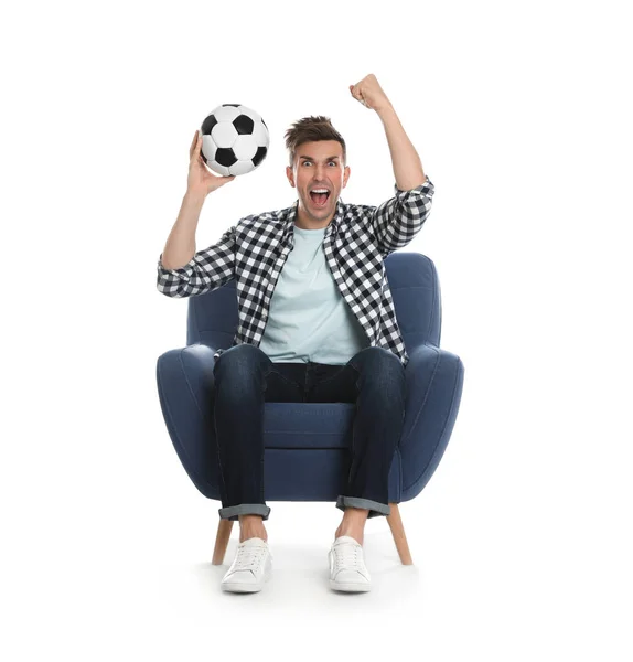 Handsome young man sitting in armchair and watching soccer match — 图库照片
