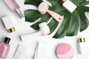 Beyaz arka planda yüz temizleme fırçaları olan kompozisyon, üst görünüm. Kozmetik araçları