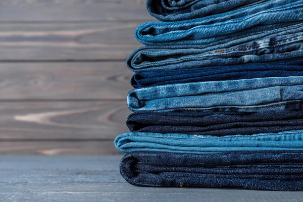 Stack Different Jeans Grey Wooden Table Closeup — Stock Photo, Image