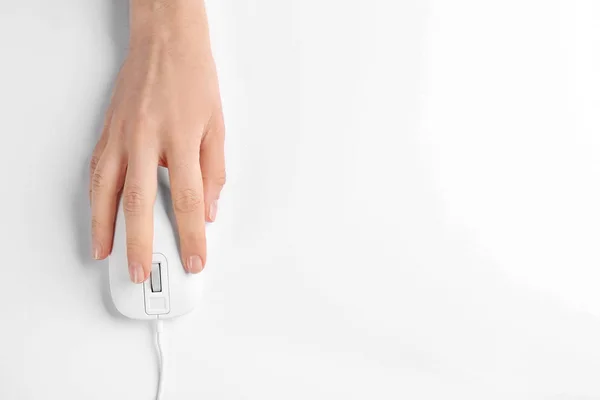 Woman using modern wired optical mouse on white background, top — Stock Photo, Image