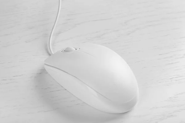 Modern wired optical mouse on white wooden table, closeup — Stock Photo, Image