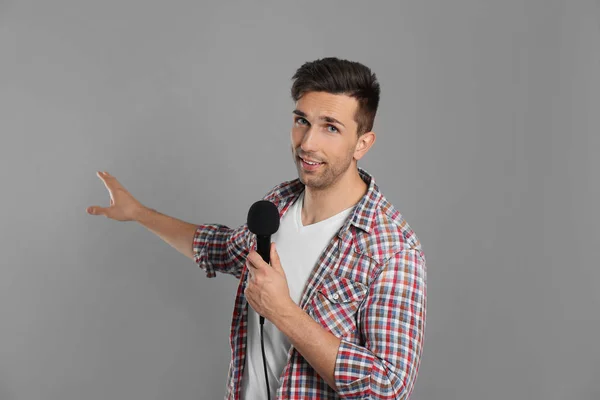 Young Male Journalist Microphone Grey Background — 스톡 사진