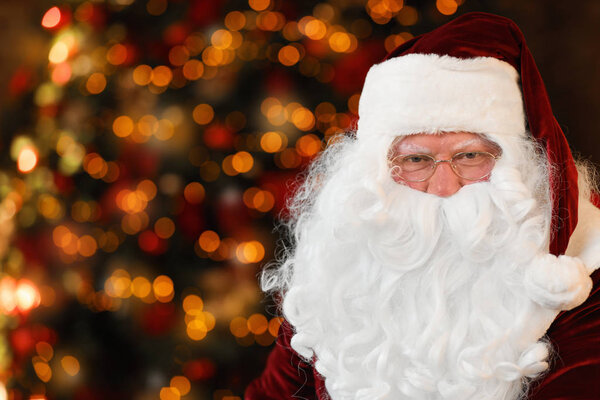 Portrait of Santa Claus on blurred background, space for text. Christmas time