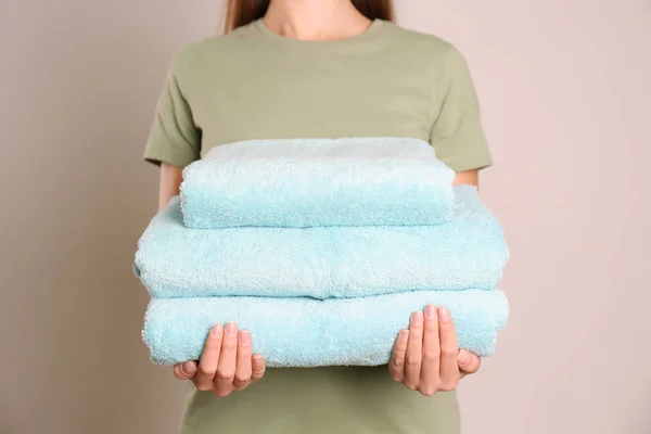 Woman Holding Stack Fresh Towels Grey Background Closeup — Stock Photo, Image