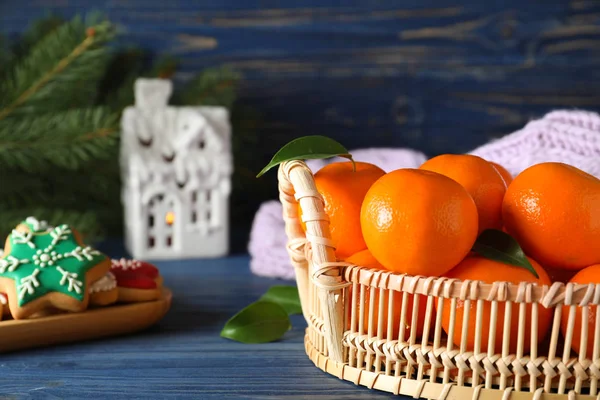 Tasty fresh tangerines on blue wooden table. Christmas celebrati — Stock Photo, Image