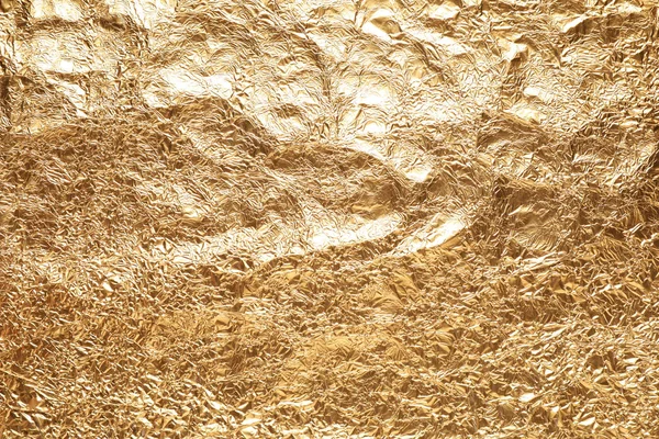 Crumpled gold foil as background, top view — Stock Photo, Image