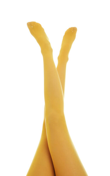 Woman wearing yellow tights on white background, closeup of legs