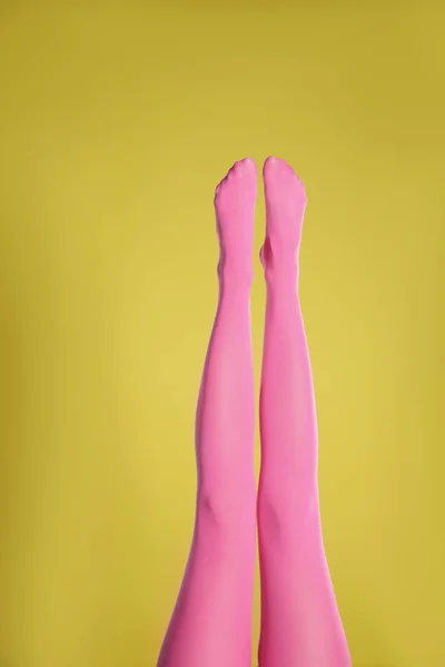 Sarı Arka Planda Pembe Tayt Giyen Kadın Bacaklarına Yakın Plan — Stok fotoğraf
