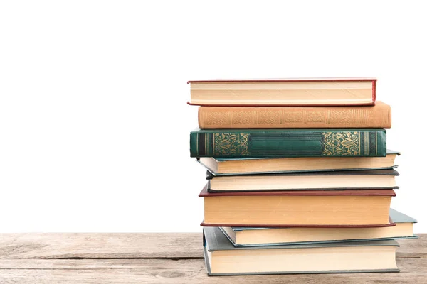 Stapel oude vintage boeken op houten tafel tegen witte backgro — Stockfoto