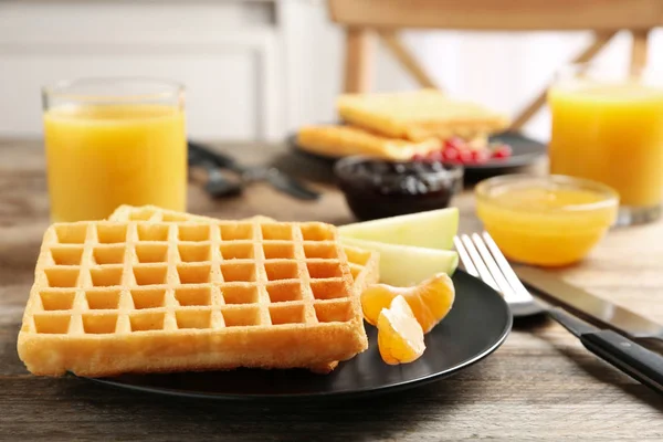 Waffles with fruits served on wooden table. Delicious breakfast — Stock Photo, Image