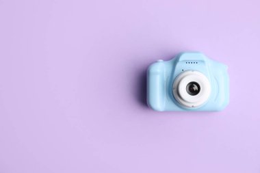 Mor arka planda açık mavi oyuncak kamera, metin için yeri olan üst görünüm. Geleceğin fotoğrafçısı.