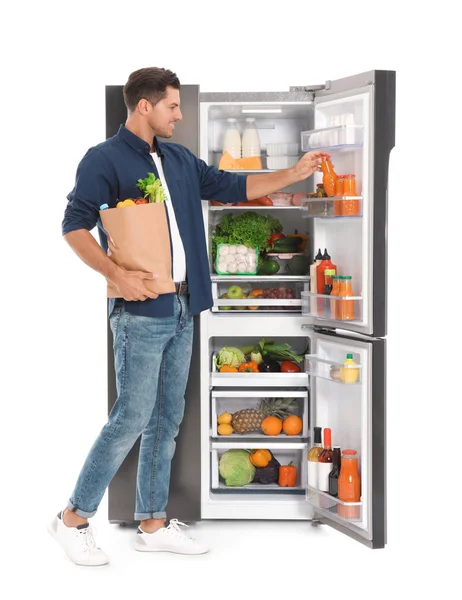 Muž Taškou Potravin Blízkosti Otevřené Chladničky Bílém Pozadí — Stock fotografie