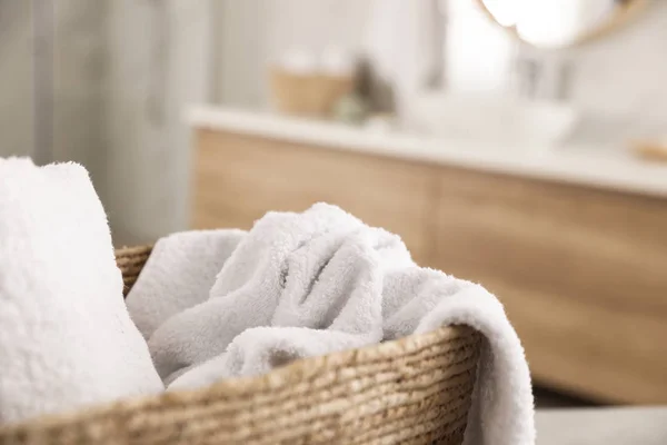 Wicker basket with clean towels in bathroom, closeup — Stock Photo, Image