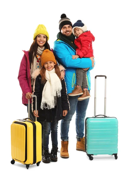 Happy family in warm clothes with suitcases on white background. Winter vacation