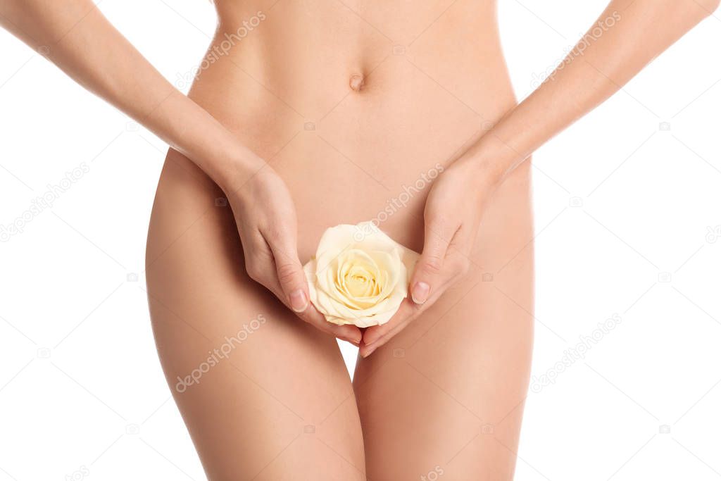 Woman with flower showing smooth skin after Brazilian bikini epilation on white background, closeup. Body care concept