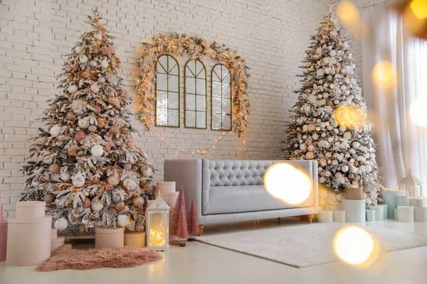 Beautiful interior of living room with decorated Christmas trees