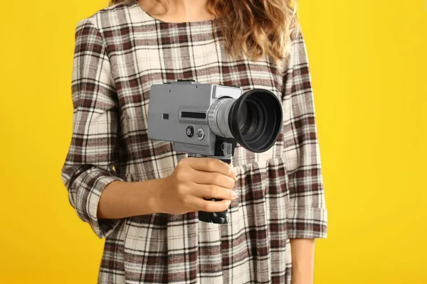 Vrouw met vintage videocamera op gele achtergrond, close up — Stockfoto