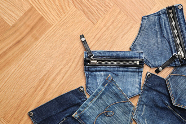 Flat lay composition with jeans pockets on table. Space for text