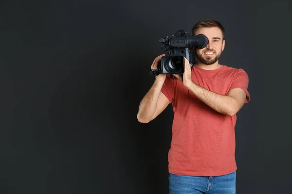 Bediener mit professioneller Videokamera auf schwarzem Hintergrund, Wellness — Stockfoto