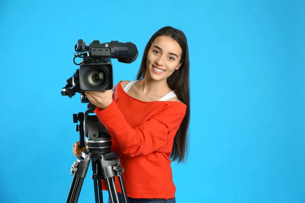 Operador con videocámara profesional sobre fondo azul —  Fotos de Stock