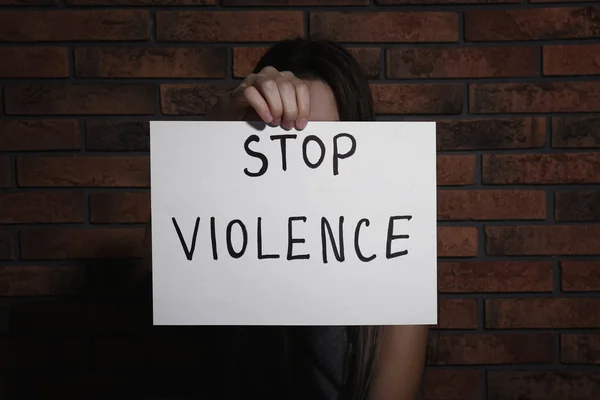 Молода Жінка Знаком Stop Violence Біля Цегляної Стіни — стокове фото