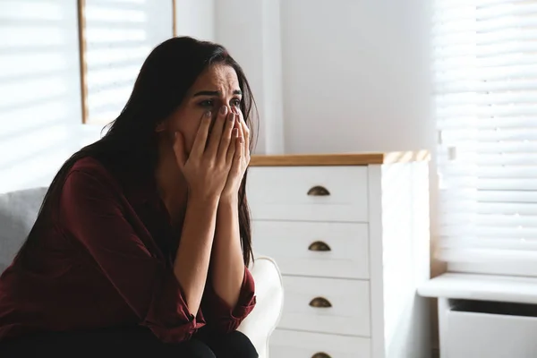 Abused young woman crying indoors, space for text. Domestic viol — Stock Photo, Image