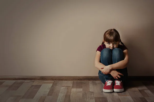 불쌍 한 작은 소녀 가 실내 바닥에 앉아 있고, 문자가 있는 공간이죠. 아이 — 스톡 사진