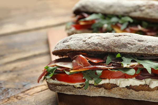 Delicious Sandwiches Fresh Vegetables Prosciutto Wooden Table Closeup — Stock Photo, Image