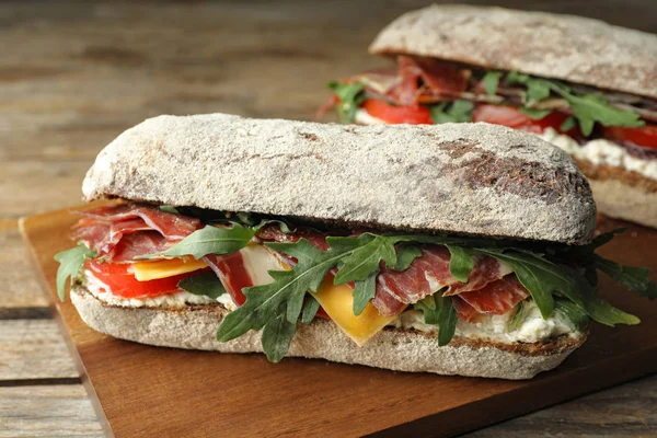 Delicious Sandwich Fresh Vegetables Prosciutto Wooden Table Closeup — Stock Photo, Image