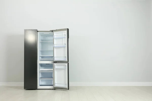Modern refrigerator near light grey wall. space for text — Stock Photo, Image