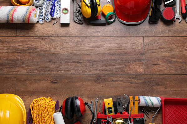 Flat lay composition with different construction tools and space for text on wooden background