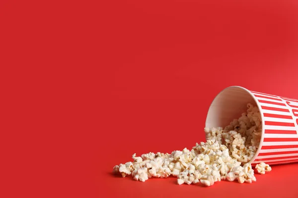Tasty pop corn on red background. Space for text