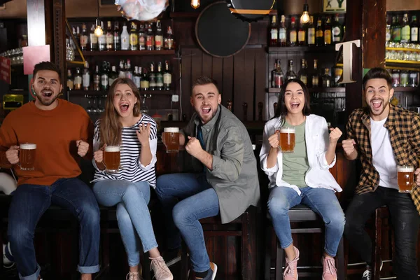 Group of friends watching football in sport bar — Stock Photo, Image