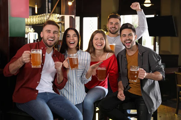 Group of friends watching football in sport bar — Stock Photo, Image