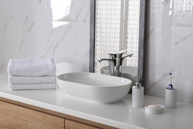 Modern mirror and vessel sink in stylish bathroom clipart